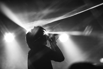 Rear view of man singing at concert