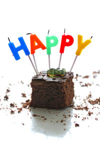 Close-up of cake on table against white background