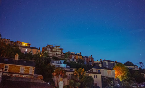 Buildings against blue sky at night