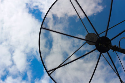 Low angle view of electric lamp against sky