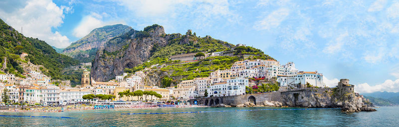 Panoramic view, aerial skyline of small haven of amalfi village with tiny beach and colorful houses,