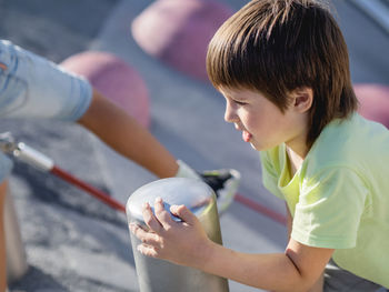 Side view of boy blowing bubbles