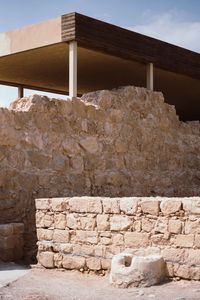 Stone wall by building