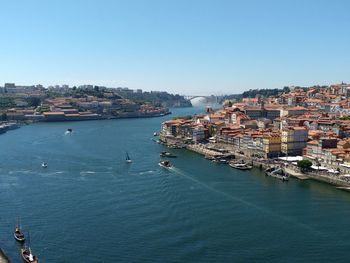 High angle view of townscape by sea against clear sky