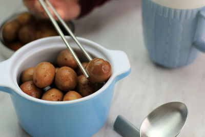 Pick brown quail egg semur telur puyuh with chopstick, banchan side dish in korean food