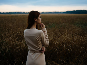 Young woman standing in field