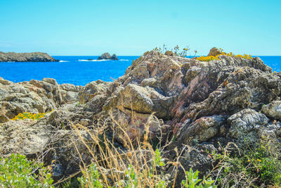 Rocks on beach against sky