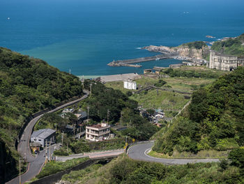 High angle view of road by sea and buildings in city