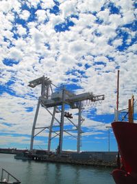View of harbor against cloudy sky