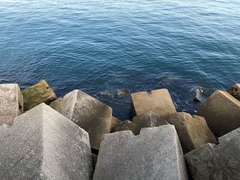 High angle view of rocks by sea