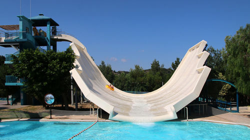 View of swimming pool against clear blue sky