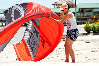 Midsection of man with red umbrella