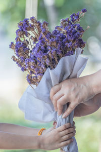 Close-up of hand holding bouquet