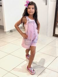 Portrait of smiling girl standing on tiled floor