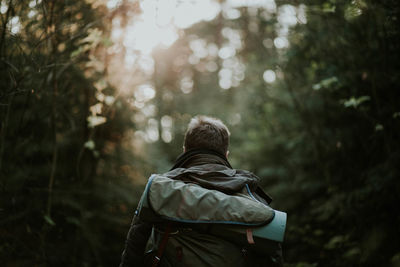 Rear view of woman walking in forest