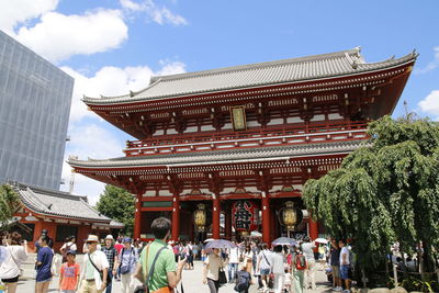 People at temple against sky