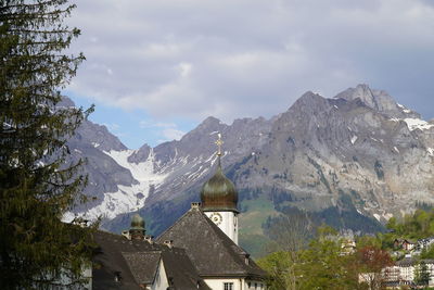 Panoramic view of building and mountains against sky