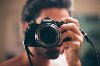 Portrait of man photographing camera