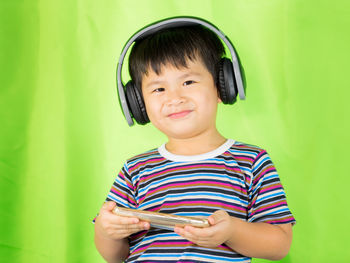 Portrait of smiling boy holding camera