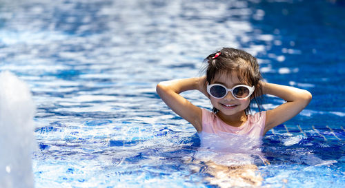 Portrait of girl swimming in pool