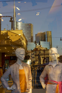 Rear view of man and woman standing on street in city