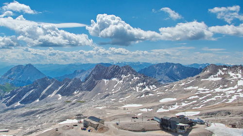 Scenic view of snowcapped mountains against cloudy sky