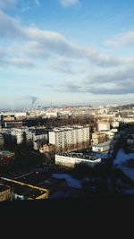 Cityscape against cloudy sky