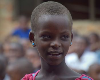 Close-up of girl looking away while standing outdoors