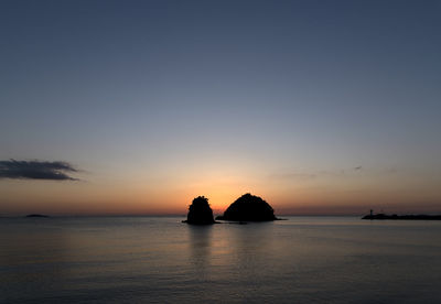 Scenic view of sea against romantic sky at sunset