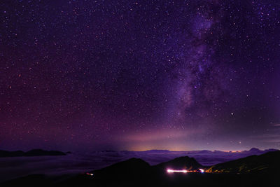 Scenic view of mountains against star field at night