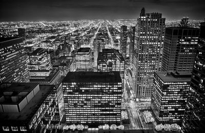 High angle view of illuminated buildings against sky at night