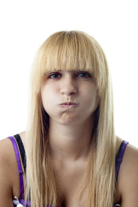 Close-up portrait of young woman against white background