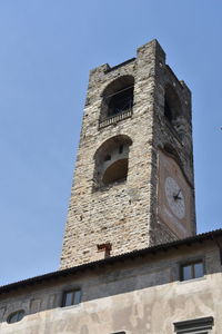 Low angle view of clock tower against clear sky