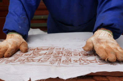 Low section of man sitting on table