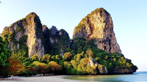 Panoramic view of rock formation in sea against clear sky