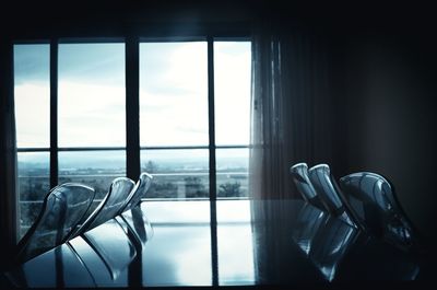 Chairs and table against window at home