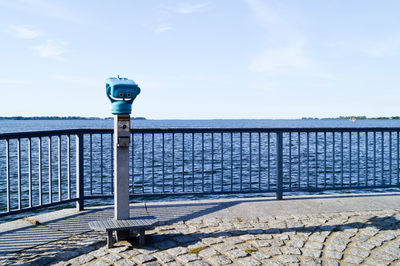 Coin-operated binoculars by sea against sky at stralsund