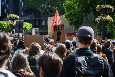 Rear view of people on street in city