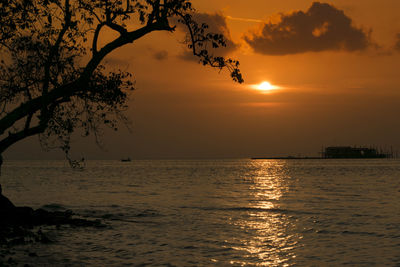 Scenic view of sea against orange sky