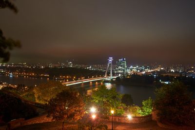 High angle view of city lit up at night