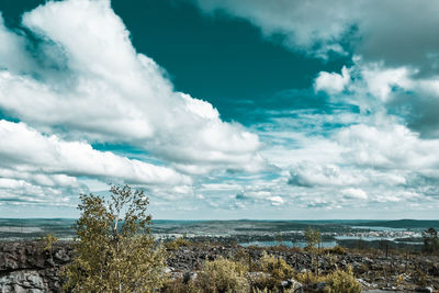 Aerial view of townscape by sea against sky