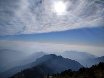 Scenic view of mountains against blue sky