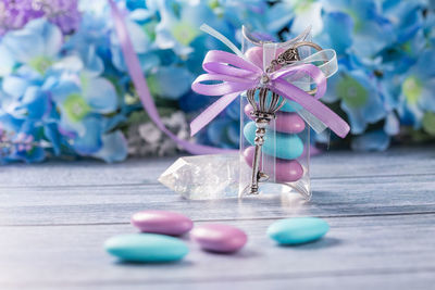 Close-up of gift candies and flowers on table