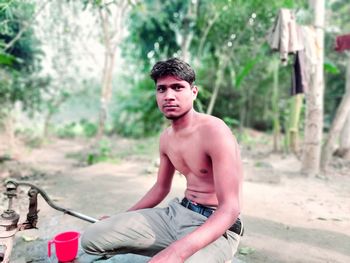 Portrait of young man sitting outdoors