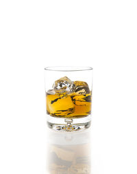 Close-up of beer glass against white background