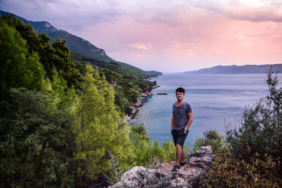 Woman standing on mountain against sky