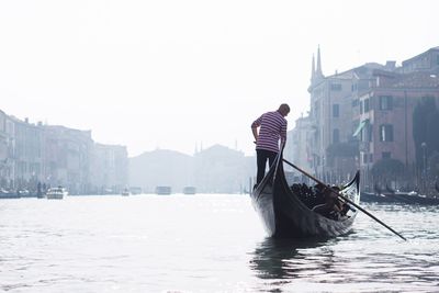 Man standing on boat in water