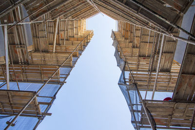 Construction site with a protective safety net on the facade of a building with scaffolding. old