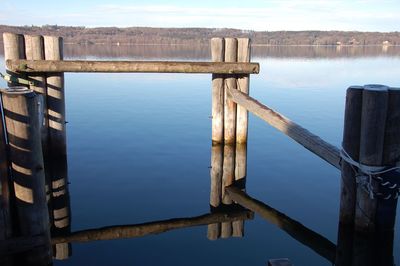 Wooden pier over lake against sky