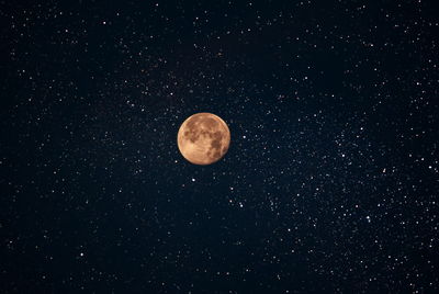 Low angle view of moon against sky at night